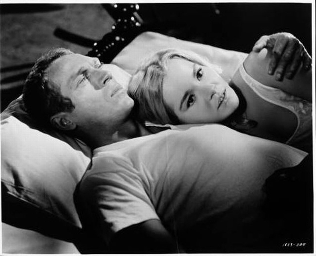 Eric (McQueen) and Christian (played by Tuesday Weld).
In his arms.